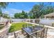 Lovely backyard features a well-manicured lawn, a stone patio, and a white fence at 650 63Rd S Ave, St Petersburg, FL 33705