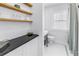 Bright bathroom featuring new tile flooring, modern fixtures and open shelving at 650 63Rd S Ave, St Petersburg, FL 33705