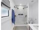 Stylish bathroom featuring a glass shower, white tile, and modern fixtures at 650 63Rd S Ave, St Petersburg, FL 33705