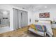 Cozy bedroom with a ceiling fan, neutral walls, a large window, and hardwood floors at 650 63Rd S Ave, St Petersburg, FL 33705