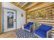 Charming covered patio features seating, a privacy screen, and direct access to the house at 650 63Rd S Ave, St Petersburg, FL 33705