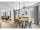 Bright dining room features modern light fixture and table with seating for six at 650 63Rd S Ave, St Petersburg, FL 33705
