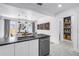 Bright, open kitchen with stainless appliances and pendant lights over the dining area at 650 63Rd S Ave, St Petersburg, FL 33705