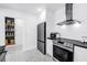 Bright kitchen features new appliances, white cabinets, and built-in shelving at 650 63Rd S Ave, St Petersburg, FL 33705