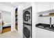Laundry room features updated washer and dryer with convenient storage and shelving at 650 63Rd S Ave, St Petersburg, FL 33705