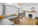 Bright living room featuring fireplace, hardwood floors, neutral colors, and an abundance of natural light at 650 63Rd S Ave, St Petersburg, FL 33705