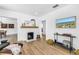 Open living room with hardwood flooring, white brick fireplace and an abundance of natural light at 650 63Rd S Ave, St Petersburg, FL 33705
