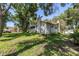 Exterior view of the house with a large backyard and mature trees at 6505 Cedar Ne St, St Petersburg, FL 33702