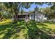 Exterior view of the house from the backyard showing the screened in porch at 6505 Cedar Ne St, St Petersburg, FL 33702
