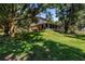 Spacious backyard showing the exterior of the house and screened in back porch at 6505 Cedar Ne St, St Petersburg, FL 33702