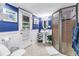 Charming bathroom features bright blue walls, white wainscoting, shower, and pedestal sink at 6505 Cedar Ne St, St Petersburg, FL 33702
