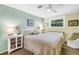 Cozy bedroom with soft green walls, a ceiling fan, and a bright window at 6505 Cedar Ne St, St Petersburg, FL 33702