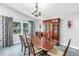 Elegant dining room with a chandelier and window, showcasing a large wooden table and china cabinet at 6505 Cedar Ne St, St Petersburg, FL 33702