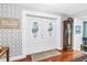 Elegant double front door opening into a foyer with hardwood floors and decorative wallpaper at 6505 Cedar Ne St, St Petersburg, FL 33702