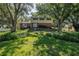 Charming two-story home featuring a brick facade and lush landscaping surrounding the property at 6505 Cedar Ne St, St Petersburg, FL 33702