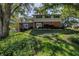 Charming two-story home with a brick facade and mature landscaping in a lush front yard at 6505 Cedar Ne St, St Petersburg, FL 33702