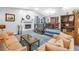 Spacious living room with a cozy fireplace, plush seating, and an adjacent dining area at 6505 Cedar Ne St, St Petersburg, FL 33702