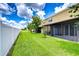 Spacious backyard with green grass and a covered patio, perfect for outdoor entertaining at 7077 Woodchase Glen Dr, Riverview, FL 33578