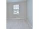Bright bedroom featuring neutral walls, carpeted floors, and a window at 7077 Woodchase Glen Dr, Riverview, FL 33578