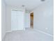 Bedroom features neutral walls, carpeted floors, closet, and access to other rooms at 7077 Woodchase Glen Dr, Riverview, FL 33578