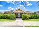 Attractive clubhouse entrance, surrounded by lush landscaping and manicured lawns at 7077 Woodchase Glen Dr, Riverview, FL 33578