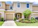 Inviting townhome with a cozy front yard and attached one-car garage at 7077 Woodchase Glen Dr, Riverview, FL 33578