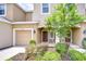 Charming townhouse featuring an attached garage, cozy entrance, and well-maintained landscaping at 7077 Woodchase Glen Dr, Riverview, FL 33578