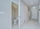 Welcoming hallway with a half bathroom, coat closet, and staircase to the second floor at 7077 Woodchase Glen Dr, Riverview, FL 33578