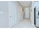 Bright hallway featuring tile flooring and access to multiple rooms at 7077 Woodchase Glen Dr, Riverview, FL 33578