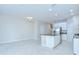 Open-concept kitchen with a center island and stainless steel appliances at 7077 Woodchase Glen Dr, Riverview, FL 33578