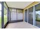 Screened in back porch with a concrete floor and large sliding glass doors at 7077 Woodchase Glen Dr, Riverview, FL 33578