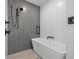 Contemporary bathroom showcases a freestanding tub, black fixtures, and minimalist design at 777 3Rd N Ave # 1406, St Petersburg, FL 33701