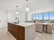 Modern kitchen island with seating overlooks the living and dining areas with a city view at 777 3Rd N Ave # 1406, St Petersburg, FL 33701