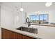 Close-up of a kitchen island with modern faucet fixtures and views into the adjacent living area at 777 3Rd N Ave # 1406, St Petersburg, FL 33701