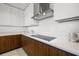 Modern kitchen details featuring white countertops and stainless steel appliances, and wood cabinets at 777 3Rd N Ave # 1406, St Petersburg, FL 33701