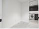 Bright laundry room with modern appliances and built-in cabinetry at 777 3Rd N Ave # 1406, St Petersburg, FL 33701