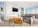 Bright lounge with a fireplace, TV, sectional sofa, and floor-to-ceiling windows at 777 3Rd N Ave # 1406, St Petersburg, FL 33701