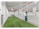 Indoor pet relief area featuring artificial grass, waste station and wash area at 777 3Rd N Ave # 1406, St Petersburg, FL 33701