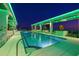 Expansive rooftop pool with clear blue water, modern lounge furniture, and vibrant city views at twilight at 777 3Rd N Ave # 1406, St Petersburg, FL 33701