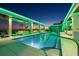 Picturesque rooftop pool area with lounge chairs, lush greenery, and scenic views of the city at dusk at 777 3Rd N Ave # 1406, St Petersburg, FL 33701