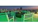 Elegant rooftop terrace highlighted with a fire pit, plush seating, and amazing city skyline views at night at 777 3Rd N Ave # 1406, St Petersburg, FL 33701