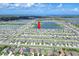 Expansive aerial view of a residential community with lakes and scenic ocean views in the distance at 797 Olive Conch St, Ruskin, FL 33570