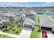 Beautiful two-story home with a well-manicured lawn, a two-car garage, and lush palm tree landscaping at 797 Olive Conch St, Ruskin, FL 33570
