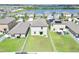 Aerial view of fenced backyard, showcasing the lot and nearby community and serene lake at 797 Olive Conch St, Ruskin, FL 33570