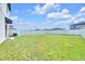 Backyard featuring lush green grass and perimeter white fence for privacy and security at 797 Olive Conch St, Ruskin, FL 33570