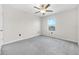Bedroom featuring carpet, a ceiling fan, window for natural light, and modern decor at 797 Olive Conch St, Ruskin, FL 33570