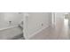Bright hallway with stairs and tile floors leading to a spacious living area at 797 Olive Conch St, Ruskin, FL 33570