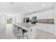Modern kitchen featuring white cabinets, granite counters, and a breakfast bar with seating at 797 Olive Conch St, Ruskin, FL 33570