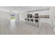 Open-concept kitchen with granite counters, stainless appliances, and an island with seating at 797 Olive Conch St, Ruskin, FL 33570