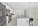 Bright kitchen featuring granite countertops, modern appliances, mosaic tile backsplash, and an island with barstool seating at 797 Olive Conch St, Ruskin, FL 33570